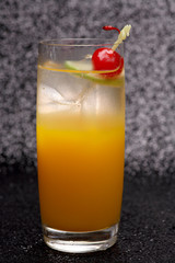 Orange cocktail drink In a clear glass on a black background