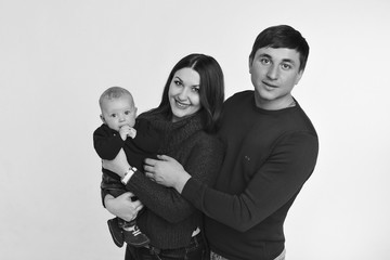 baby on the hands of parents on a white background.