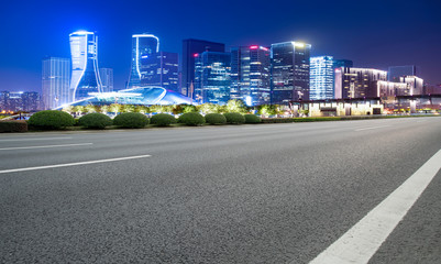 Obraz premium Road Pavement and Night View of Hangzhou Urban Architecture..