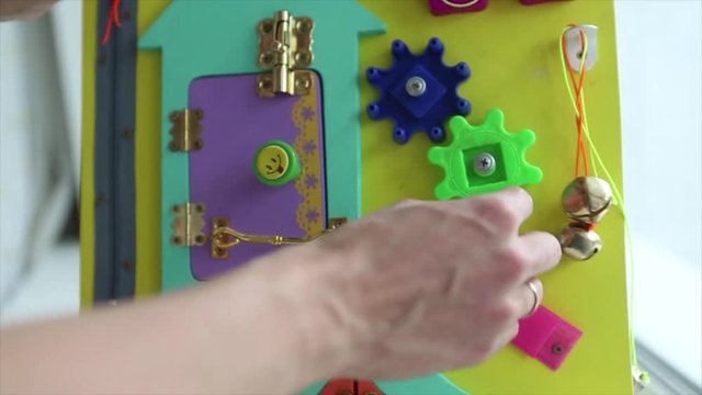 demonstration of torque parts on blackboard. Woman playing with children's educational toy