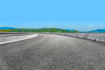 Empty asphalt road and natural landscape under the blue sky