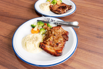 Pork steak with vegetables On the wood background