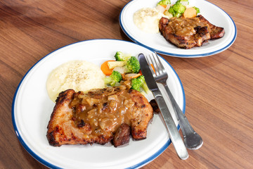 Pork steak with vegetables On the wood background