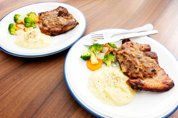 Pork steak with vegetables On the wood background
