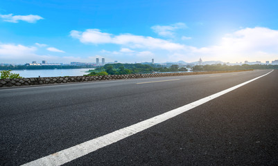 Fototapeta premium Empty asphalt road square and natural landscape under the blue sky