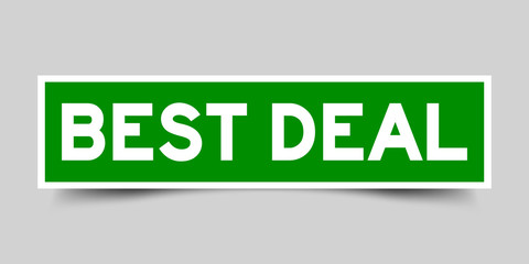 Green and white sticker with word best deal on gray background
