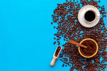 coffee background with beans and cup of americano blue table flat lay space for text