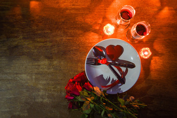 Valentines dinner romantic love conceptRomantic table setting decorated with fork spoon on plate and couple champagne glass wine