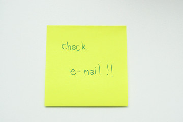 isolated handwriting on sticky note for reminder of checking e-mail