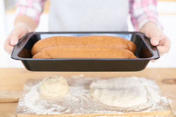 Black pan. Ready-made pastries.Raw dough. Wooden table