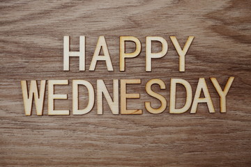 Happy Wednesday text message on wooden background