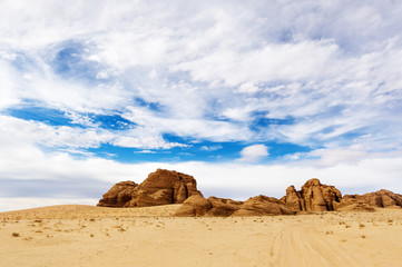 Fototapeta na wymiar Dramatic wide angle shot of the barren desert landscape in Wadi Rum