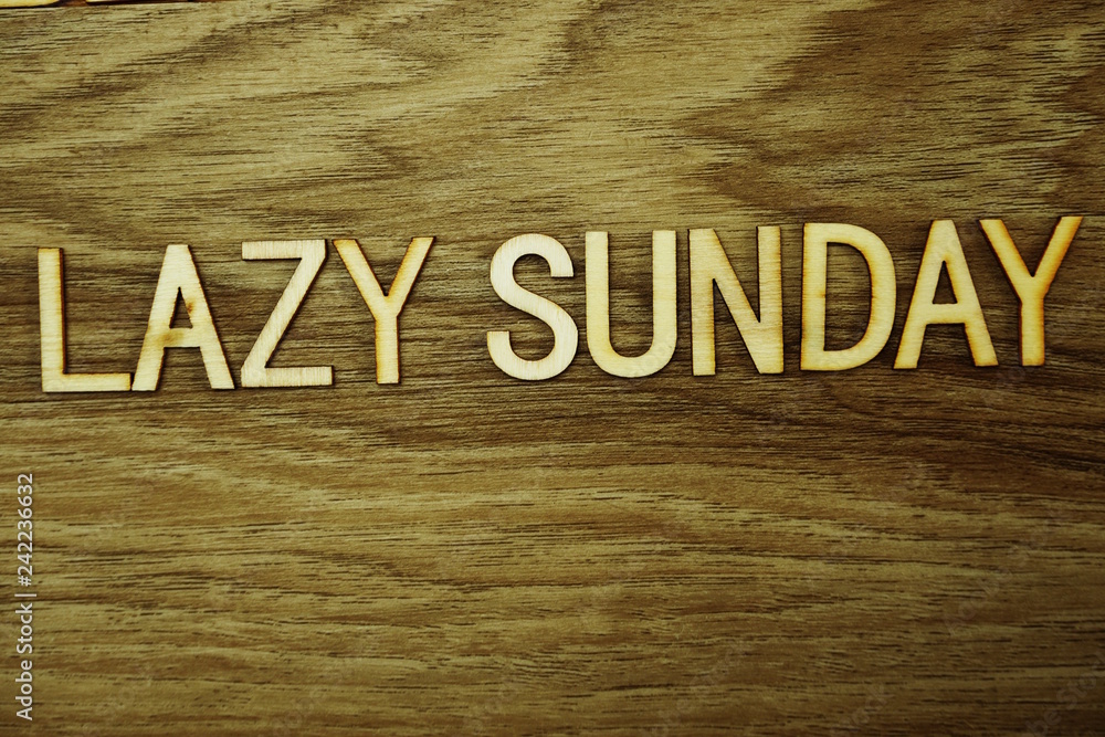 Poster lazy sunday text message on wooden background