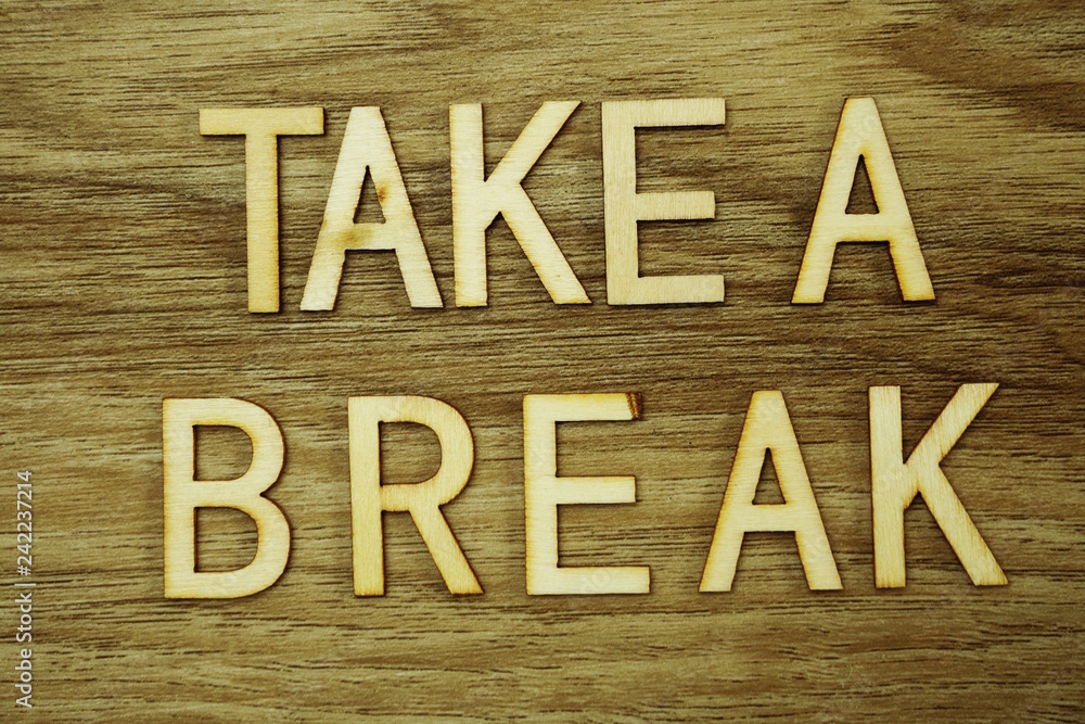 Poster take a break text message on wooden background