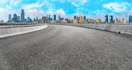 Empty asphalt road along modern commercial buildings in China,s cities