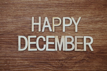 Happy December text message on wooden background
