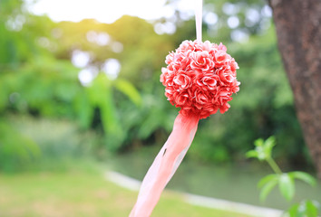 Bush of decoration artificial rose hanging in the nature park.