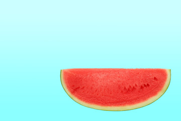 Sliced sweet watermelon isolated over cyan background with copy space.