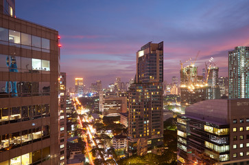 Fototapeta na wymiar Closeup modern business skyscrapers and high-rise buildings, commercial center. Bangkok night scene .