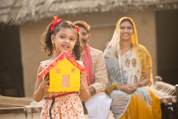 Little indian girl holding dream house model