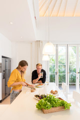 Couple cooking on a white kitchen at home