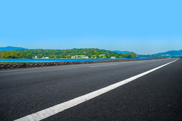Empty asphalt road and natural landscape under the blue sky