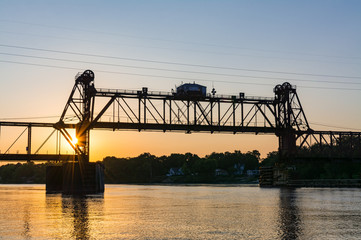 Fototapeta na wymiar Ottawa Railroad Bridge as the sun sets on the Illinois River. Ottawa, Illinois, USA
