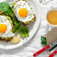 Top view healthy avocado toasts breakfast lunch fried eggs cup tea healthy breakfast
