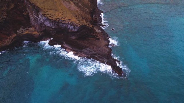 Aerials shots of Hanauma Bay, Oahu, Hawaii. Deep blue Pacific Ocean and coral reefs meet the yellow sand beach and rocky shores. Koolau mountains and Hawaii Kai in the background. 
