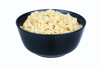 Cooked brown rice in black bowl isolated on white background with clipping path. cooked brown rice. organic food..