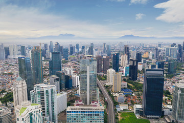 Naklejka premium Office buildings in misty mountain background