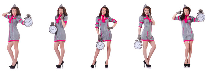 Young stewardess with alarm-clock in time management concept 