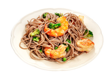 A plate of soba, buckwheat noodles, with shrimps and vegetables, isolated on a white background with a clipping path