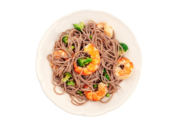 A plate of soba, buckwheat noodles, with shrimps and vegetables, shot from above, isolated on a white background with a clipping path