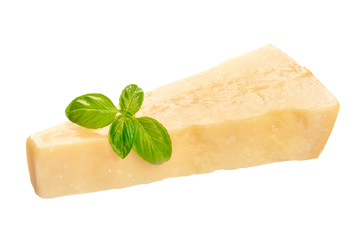 A piece of aged Parmesan cheese with fresh basil leaves, isolated on a white background with a clipping path