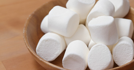Fototapeta na wymiar White cotton candy on wooden plate