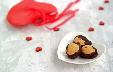 Homemade candies Buckeyes of peanut butter, covered with dark chocolate, on a gray background. Valentine's day concept.