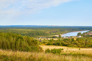 Beautiful view from the height of the landscape with fields, forests and river