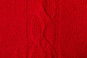 Knitted red woolen texture. Fabric background top view.