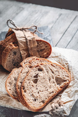 Slices of tasty whole wheat bread on a wooden table. Close-up