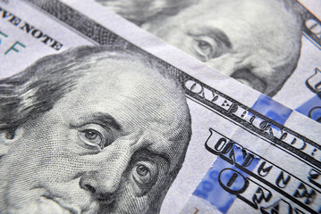 Dolar USA close up. Franklin eyes macro. The texture of the fragment of the dollar bill. USD...