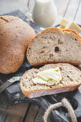 Slices of tasty whole wheat bread on a wooden table. Close-up © oksanamedvedeva