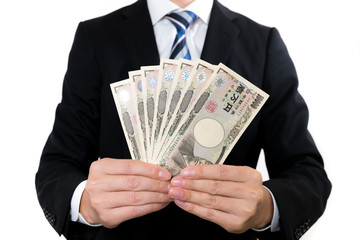 一万円札を持つビジネスマン