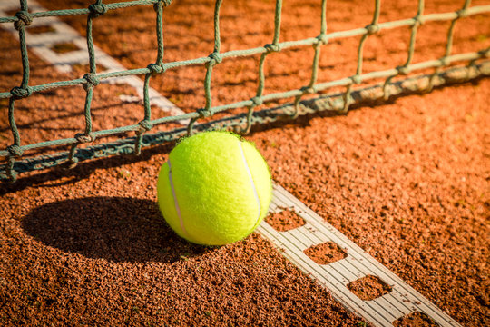 tennis ball with line on a sand court