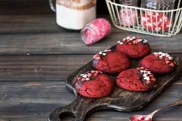 Cookies red velvet in chocolate glaze with the decor of sugar hearts