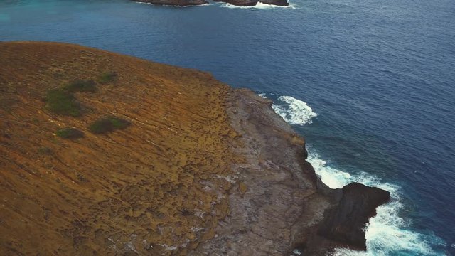 Aerials shots of Hanauma Bay, Oahu, Hawaii. Deep blue Pacific Ocean and coral reefs meet the yellow sand beach and rocky shores. Koolau mountains and Hawaii Kai in the background. 