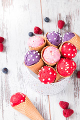 Ice cream scoop in sweet cone on wooden table.  