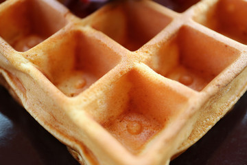 Closed Up the Texture of a Tasty Square Shaped Waffle on a Black Plate 