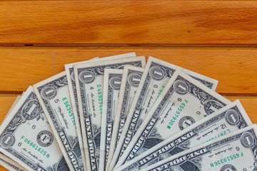 American one dollar bills on wooden background. Top view, copy space