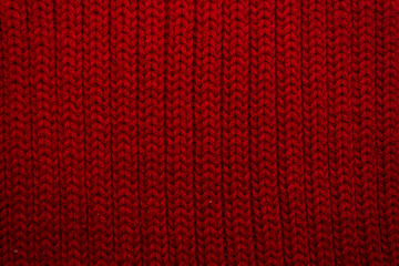 Texture of red knitted scarf close-up, red knitted wool 